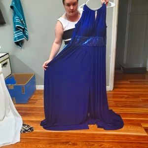 Royal blue formal dress, zips up partly in the back and ties at the top.
